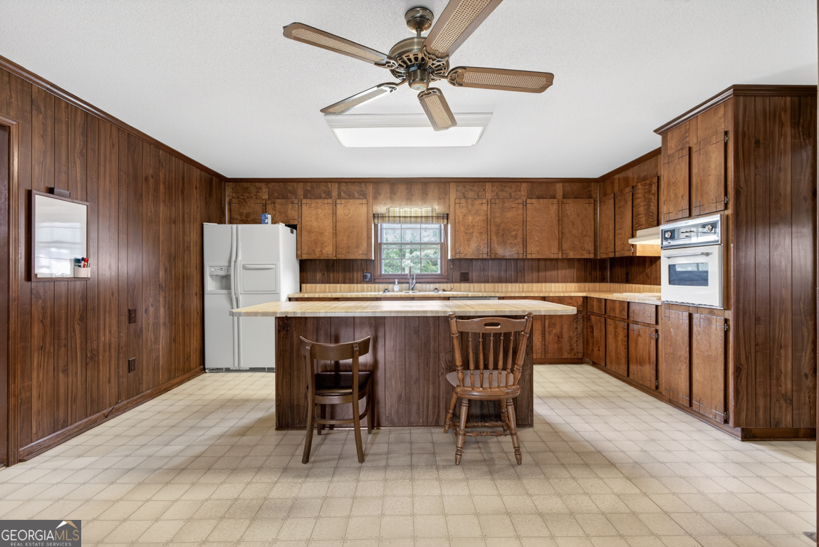 3369 Sandy Circle Macon, GA 31216 - Photo 10 of 65 a kitchen with stainless steel appliances a refrigerator a stove a sink and chairs