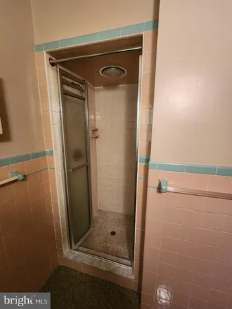 a bathroom with a glass shower door