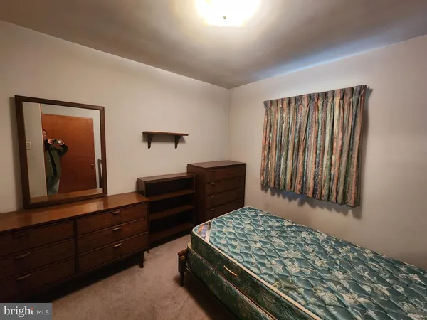 a bedroom with a bed and a dresser