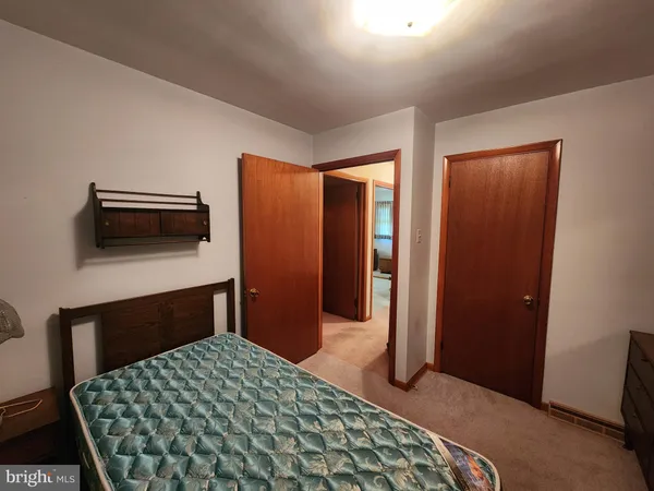 a bedroom with a bed and a dresser