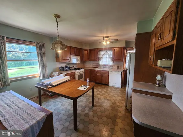 a view of kitchen with a sink and cabinets