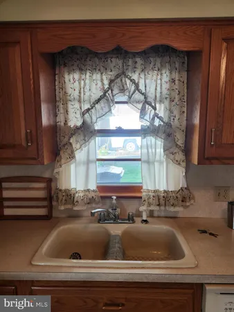 a view of kitchen with a sink and cabinets