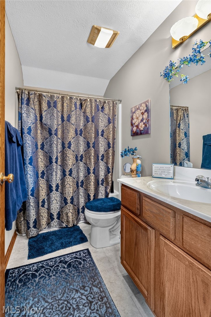 2601 Charing Cross Road Northwest Canton, OH 44708 - Photo 20 of 49 Bathroom featuring a built-in vanity with wood-finish cabinetry, a white basin, and a light-colored countertop