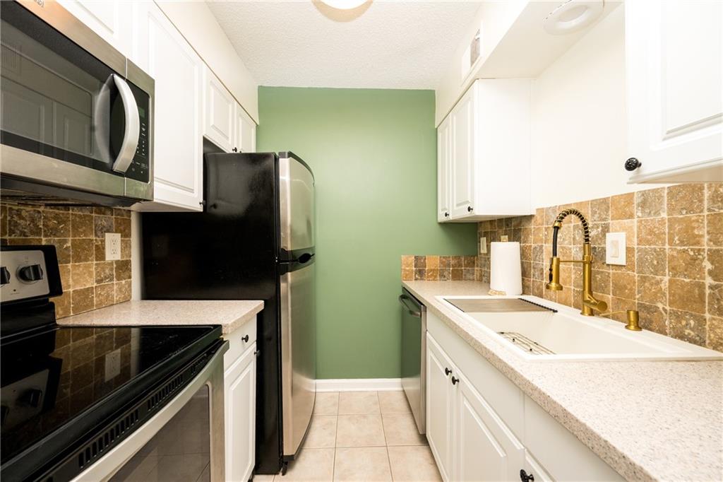 127 Lablanc Way Northwest Atlanta, GA 30327 - Photo 12 of 25 a kitchen with a sink stove and microwave