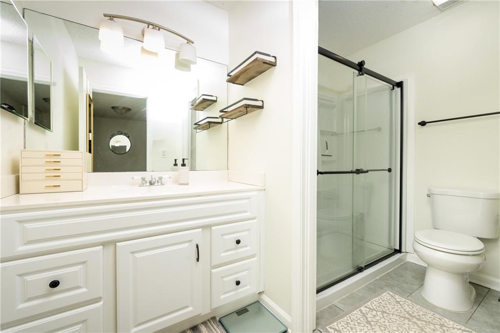 127 Lablanc Way Northwest Atlanta, GA 30327 - Photo 19 of 25 a bathroom with a sink a toilet and shower