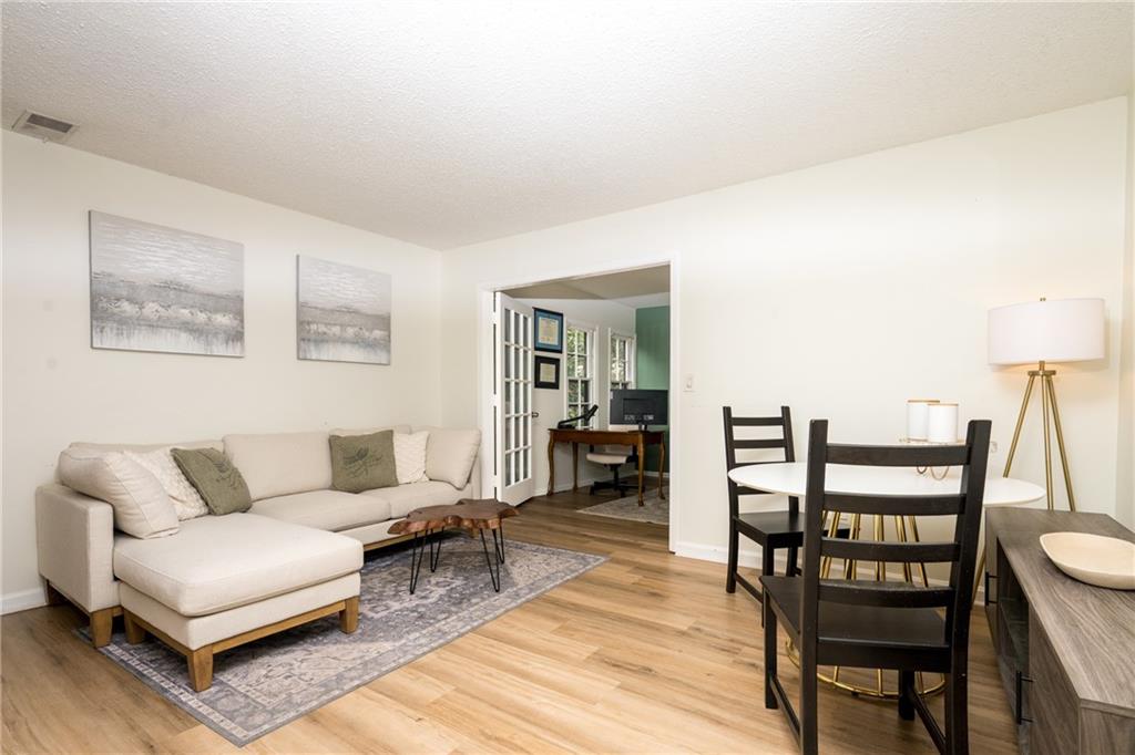 127 Lablanc Way Northwest Atlanta, GA 30327 - Photo 2 of 25 a living room with furniture a rug and a table