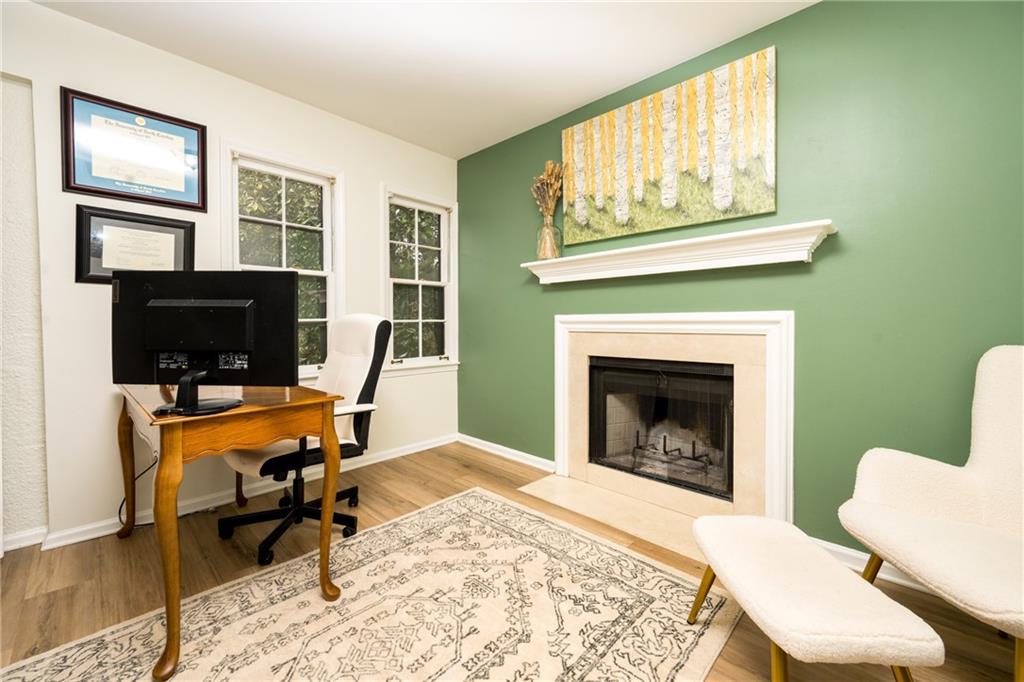 127 Lablanc Way Northwest Atlanta, GA 30327 - Photo 6 of 25 a living room with furniture a fireplace and a flat screen tv