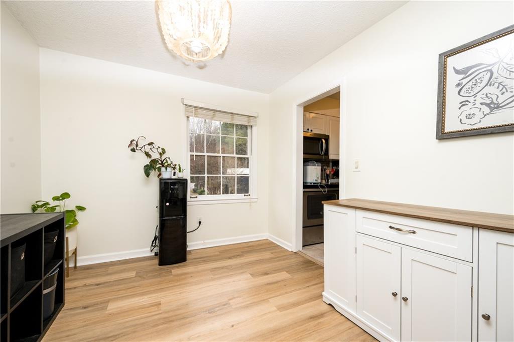 127 Lablanc Way Northwest Atlanta, GA 30327 - Photo 10 of 25 a view of an empty room with a window and wooden floor