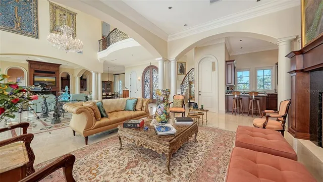 a living room with furniture fireplace and a large window