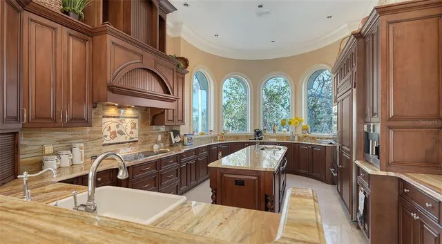 a large kitchen with a large window and stainless steel appliances