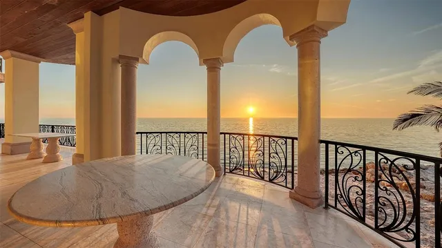 a living room with furniture a flat screen tv and a table