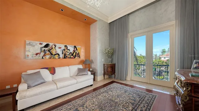 a spacious bedroom with a large bed and a chandelier