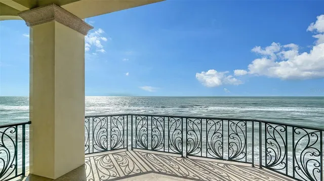 a balcony with table and chairs
