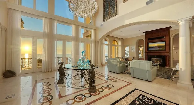 a living room with furniture and floor to ceiling windows