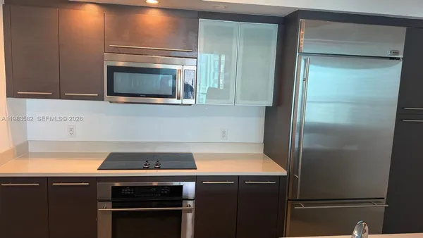 a kitchen with a refrigerator and a stove