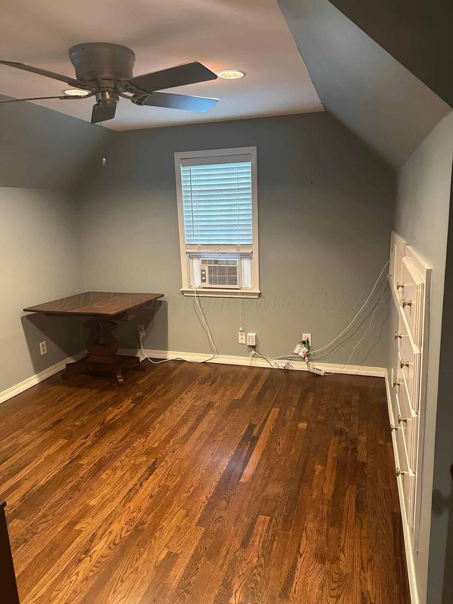 1118 Bellaire Street Amarillo, TX 79106 - Photo 28 of 36 a room with a bed and a chandelier