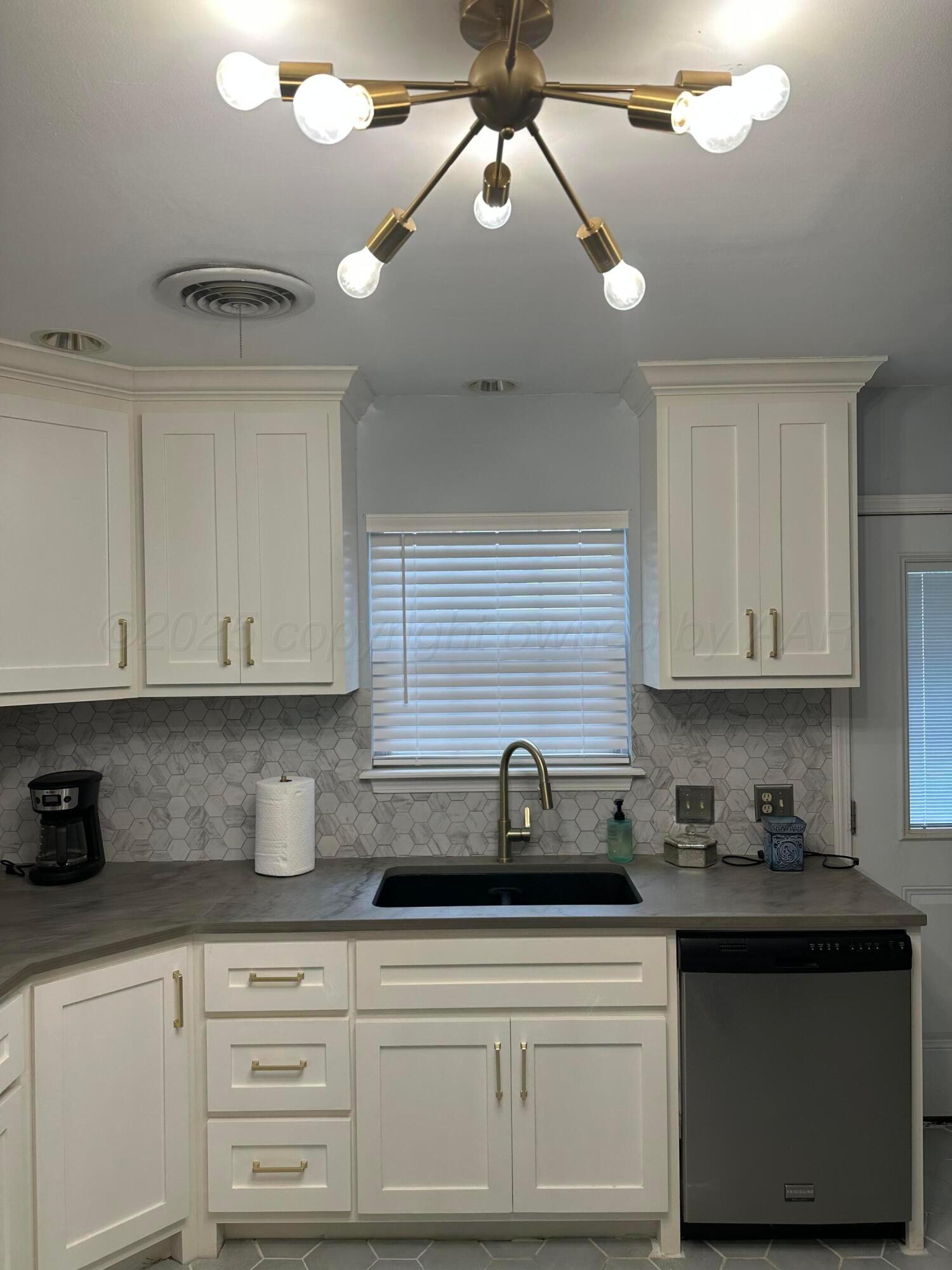 1118 Bellaire Street Amarillo, TX 79106 - Photo 6 of 36 a kitchen with stainless steel appliances granite countertop a sink a stove and cabinets