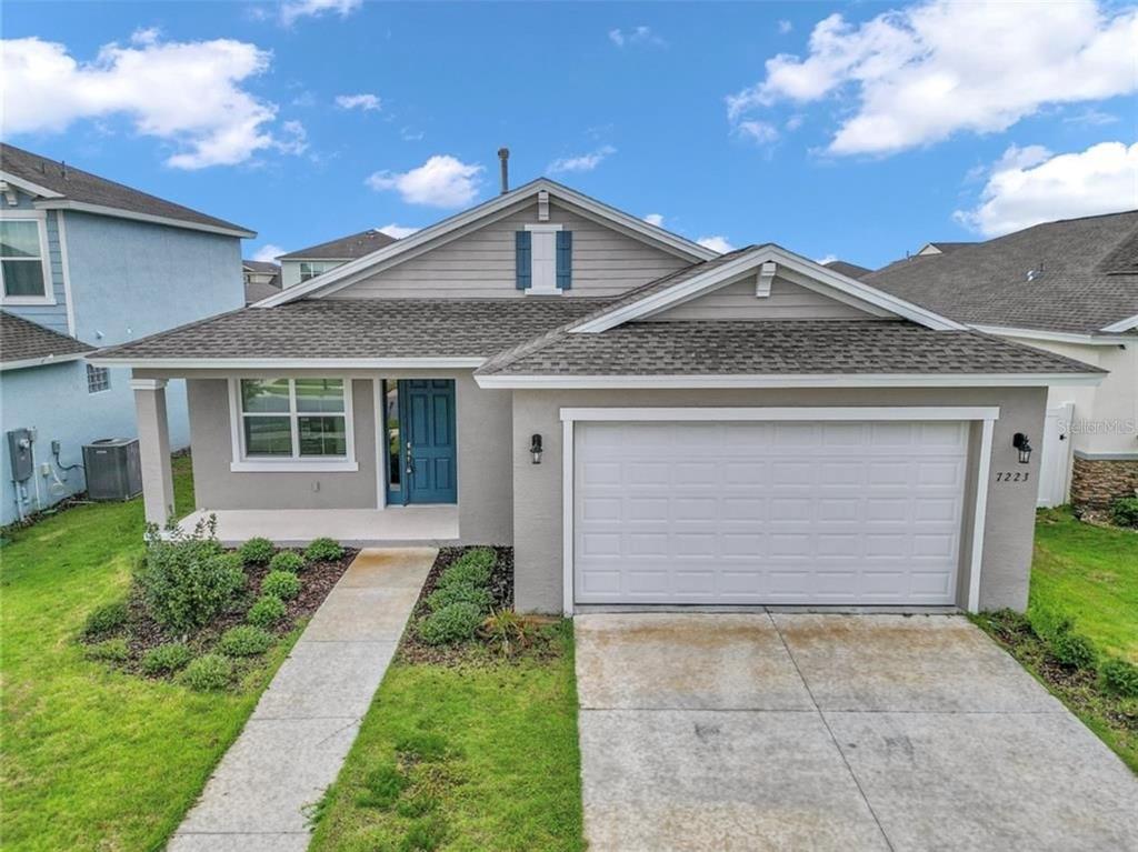 a front view of a house with a yard and garage