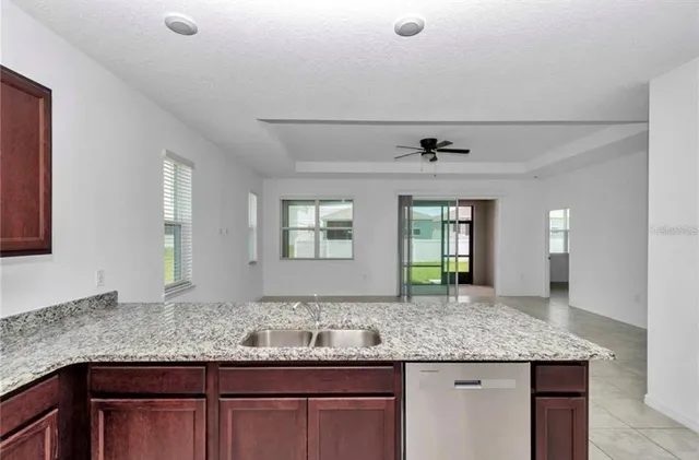 a bathroom with a granite countertop sink and a large mirror