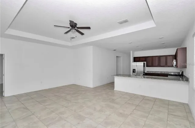 a view of kitchen with furniture and ceiling fan