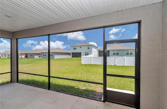 a view of an empty room with a ceiling fan