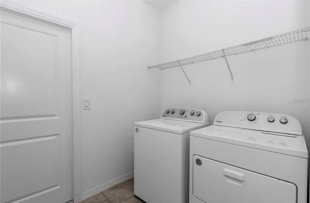 a view of storage and utility room with washer and dryer