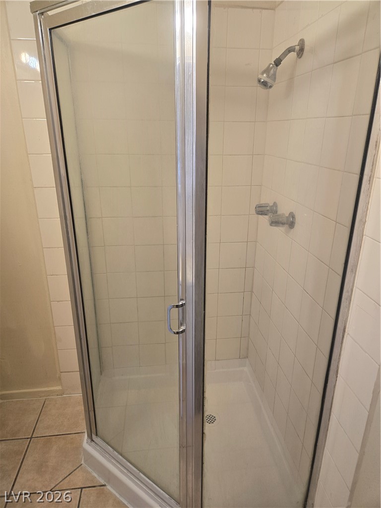 1388 East Desert Inn Road, Unit 2 Las Vegas, NV 89169 - Photo 11 of 23 A well-maintained shower stall with tiled walls and a sliding glass enclosure awaits rejuvenation.