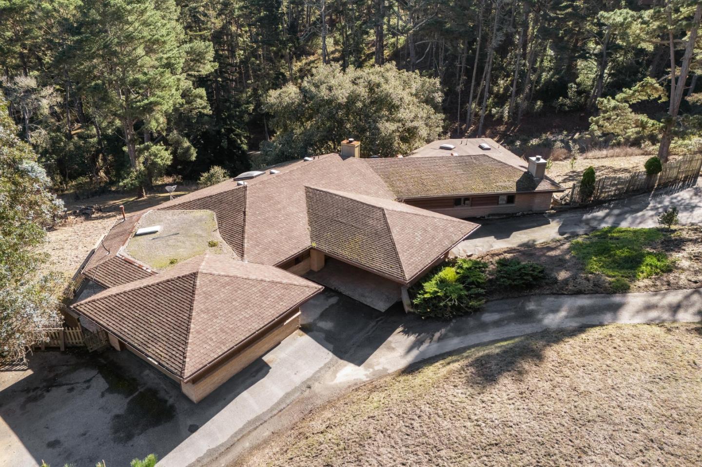 537 Aguajito Road Carmel, CA 93923 - Photo 3 of 7 an aerial view of a house with a yard and large tree