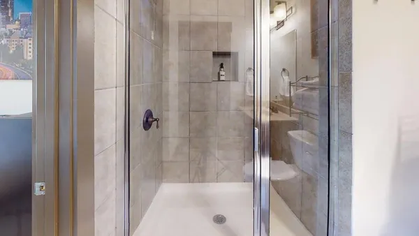 a bathroom with a glass shower door
