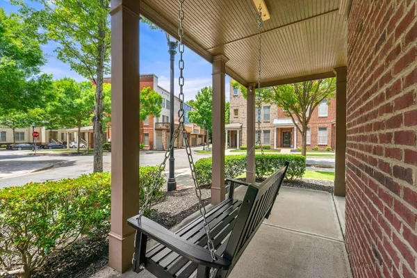 a view of a balcony with floor to ceiling windows with wooden floor
