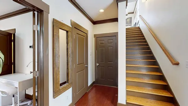 a view of an entryway with wooden floor and door