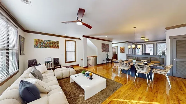 a living room with furniture and wooden floor