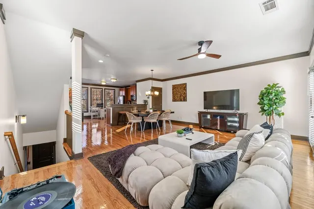 a living room with furniture a fireplace and a flat screen tv