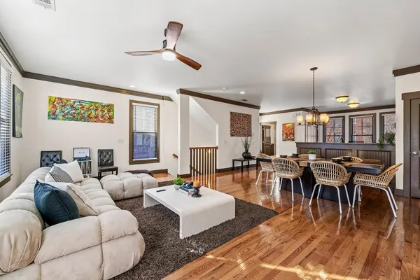 a living room with lots of furniture and a wooden floor