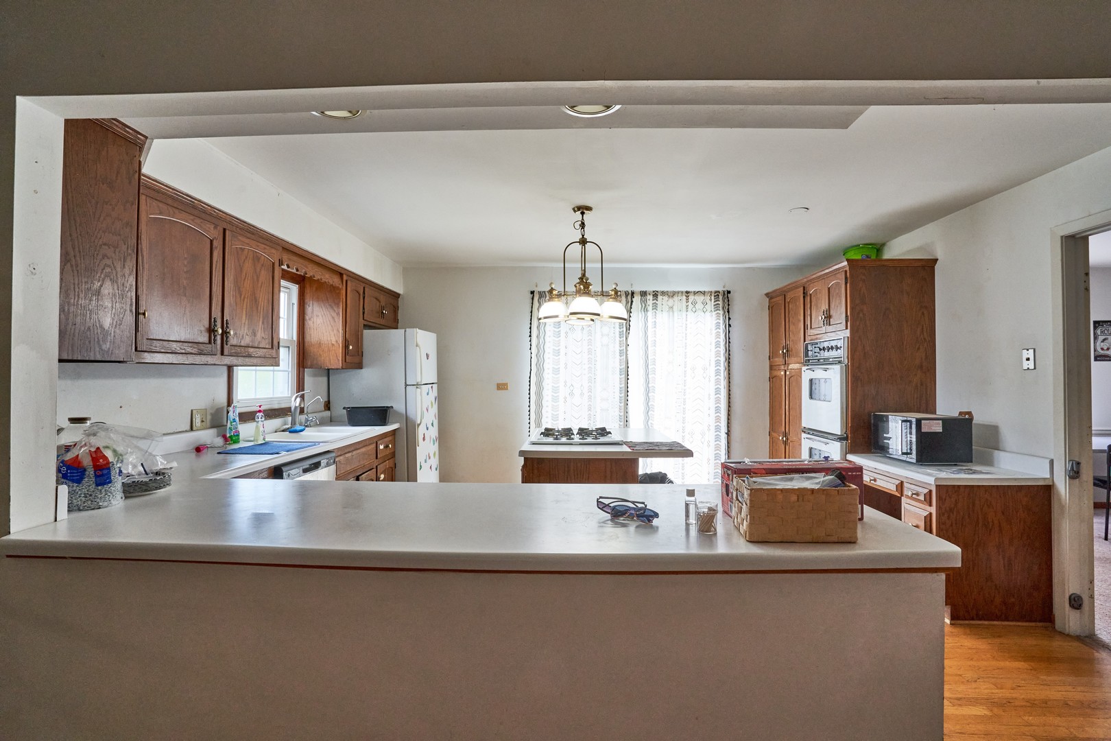 24W175 Hobson Road Naperville, IL 60540 - Photo 12 of 30 a kitchen with kitchen island a large counter top appliances and cabinets