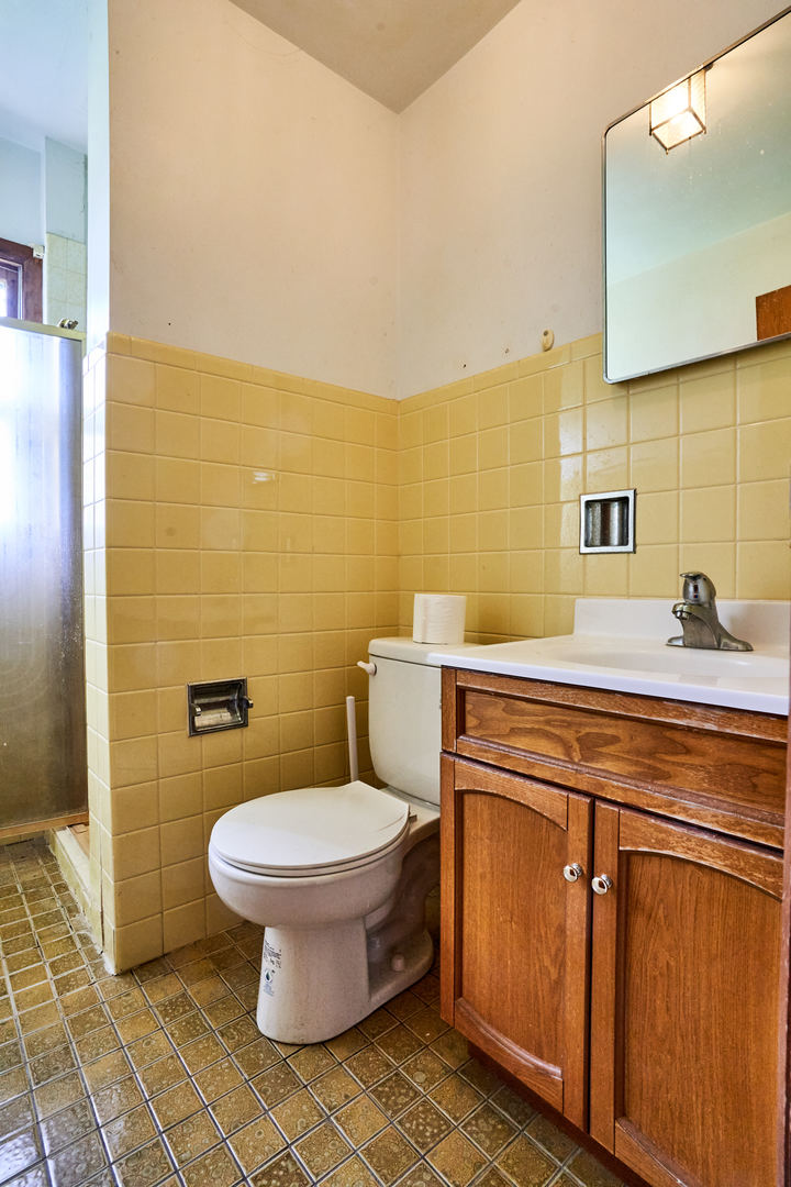 24W175 Hobson Road Naperville, IL 60540 - Photo 19 of 30 a bathroom with a sink a toilet and mirror