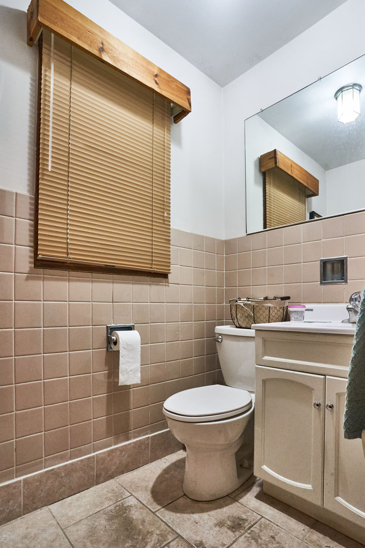 24W175 Hobson Road Naperville, IL 60540 - Photo 25 of 30 a bathroom with a toilet sink and mirror