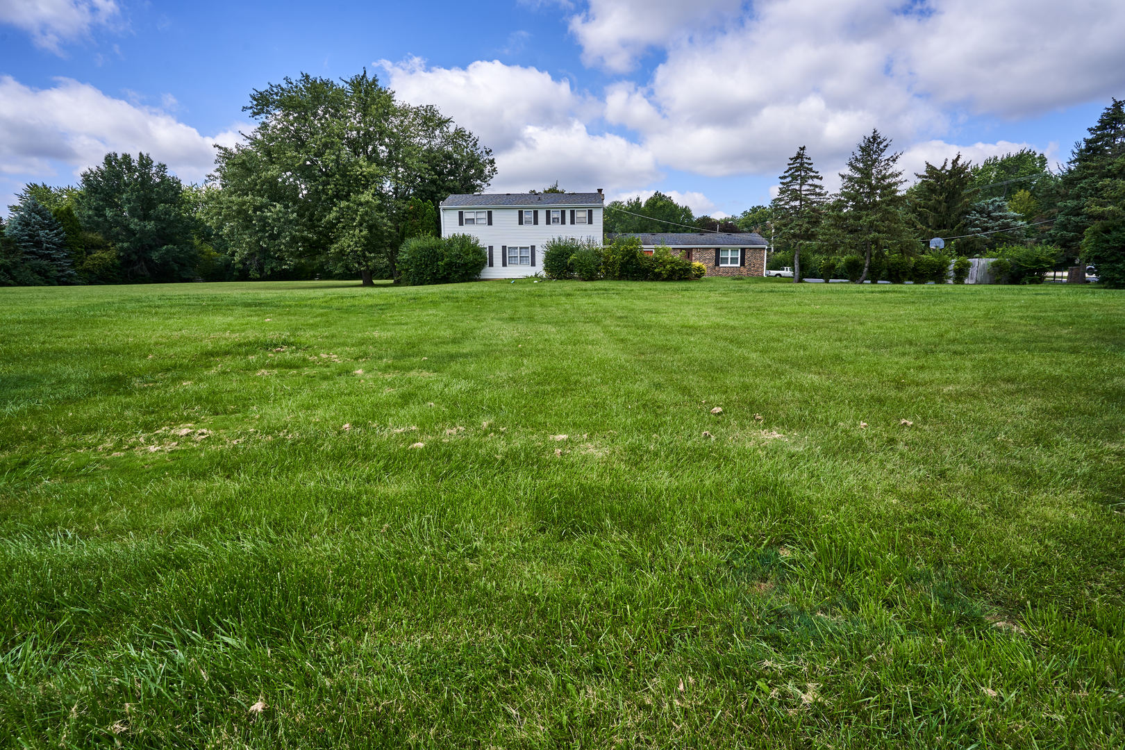 24W175 Hobson Road Naperville, IL 60540 - Photo 5 of 30 a view of a garden with a building in the background