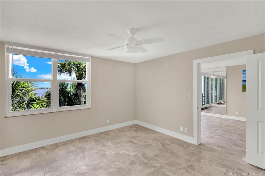 1950 Southwest Palm City Road, Unit 14305 Stuart, FL 34994 - Photo 38 of 70 an empty room with windows and outdoor view