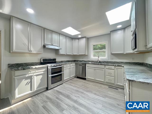 2583 Rio Mills Road Earlysville, VA 22936 - Photo 11 of 41 a kitchen with stainless steel appliances granite countertop a stove sink and cabinets
