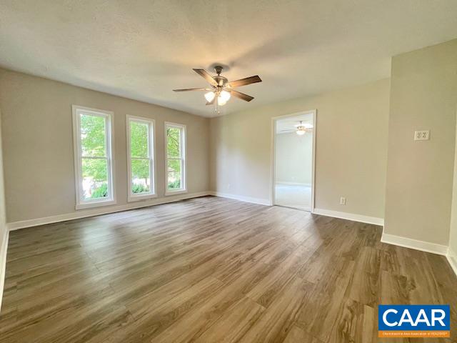 2583 Rio Mills Road Earlysville, VA 22936 - Photo 20 of 41 an empty room with wooden floor and windows