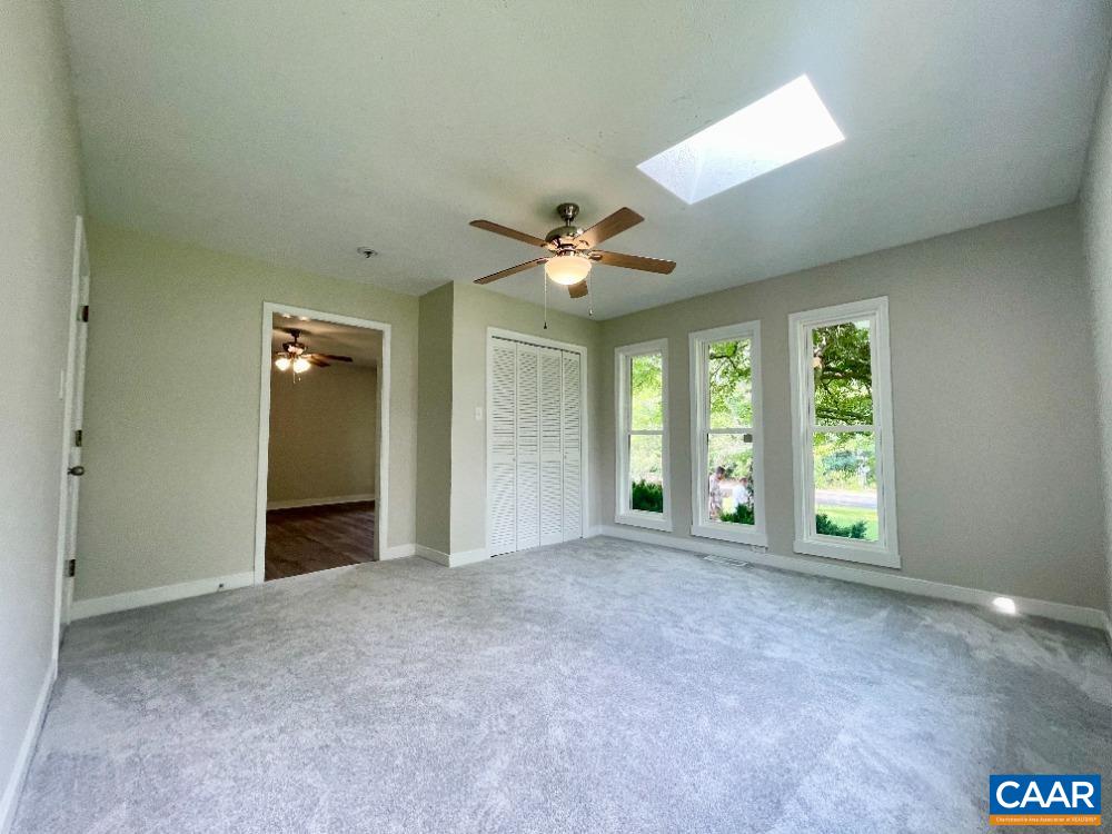 2583 Rio Mills Road Earlysville, VA 22936 - Photo 21 of 41 an empty room with windows and ceiling fan