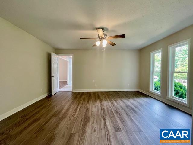 2583 Rio Mills Road Earlysville, VA 22936 - Photo 22 of 41 an empty room with wooden floor and windows