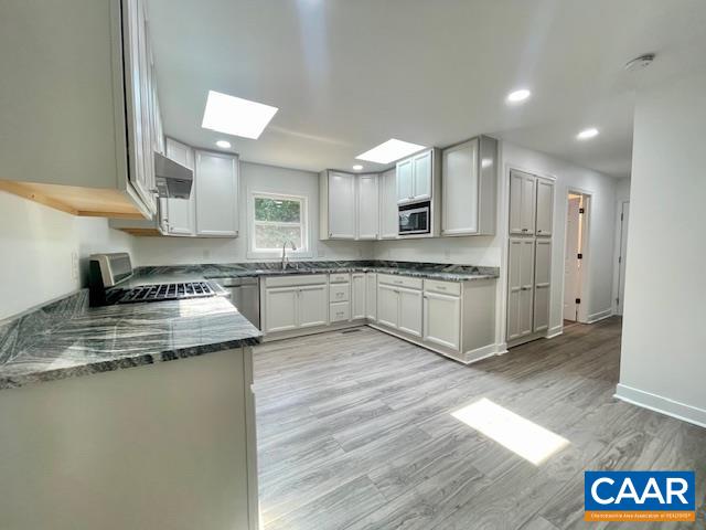 2583 Rio Mills Road Earlysville, VA 22936 - Photo 10 of 41 a kitchen with stainless steel appliances granite countertop a stove a sink and a microwave