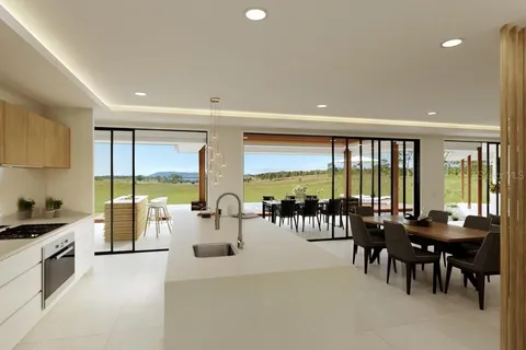 a view of a large kitchen with dining room and chandelier