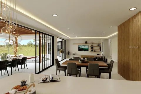 a view of a dining room with furniture and floor to ceiling window