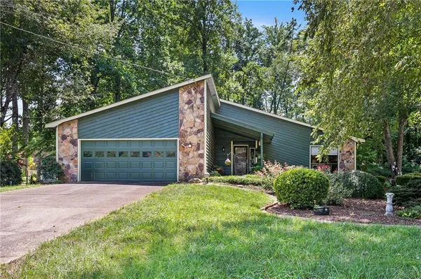 a front view of house with yard and green space