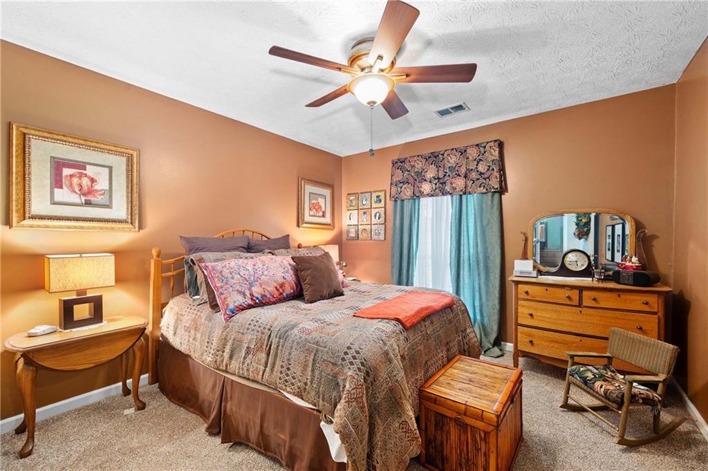 1528 Forest Trace Marietta, GA 30066 - Photo 17 of 26 a bedroom with a bed and a chandelier