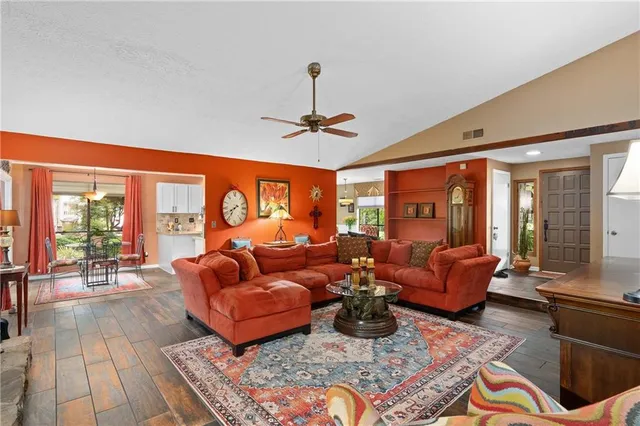 a living room with furniture ceiling fan and a rug