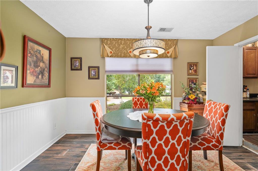 1528 Forest Trace Marietta, GA 30066 - Photo 8 of 26 a view of a dining room with furniture a chandelier and wooden floor